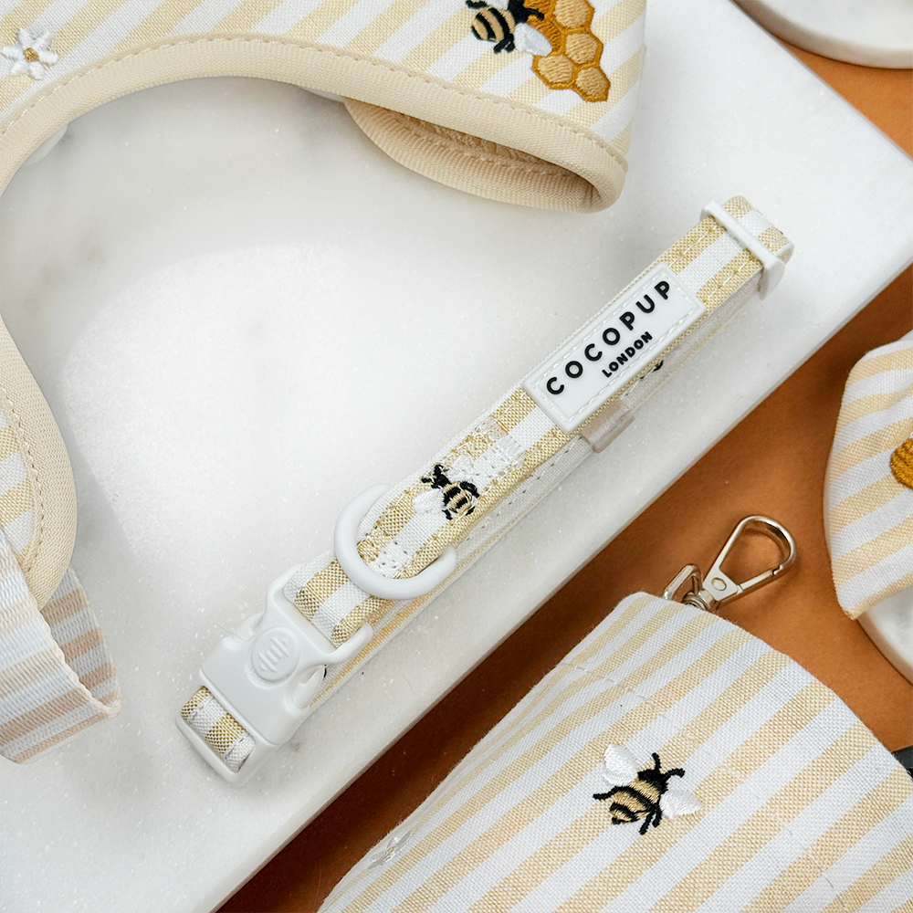 Pale yellow and white striped Dog Collar with bee and honeycomb embroidered decals. 