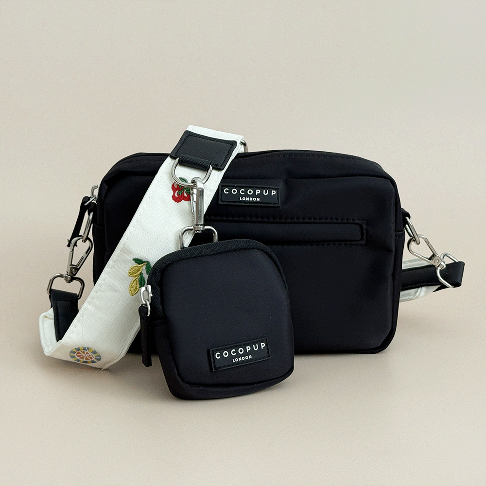 Cocopup Black Dog Walking Bag & small Treat Pouch, with white Bag Strap attached which has embroidered icons of lemons, tomatoes and more. 