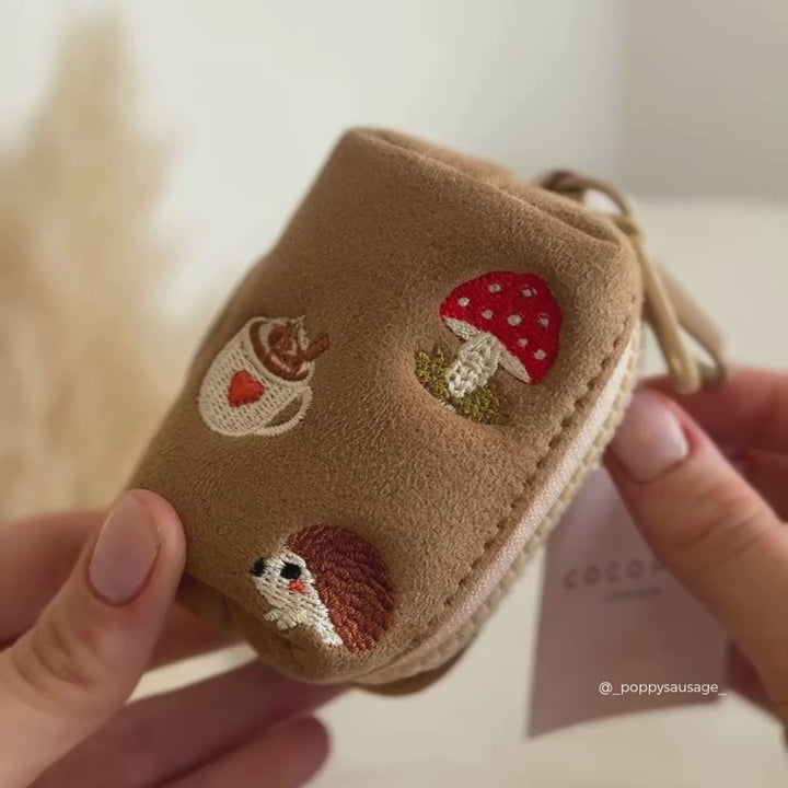 a dog poop bag holder and matching lead in a tan suede with embroidered autumnal icons
