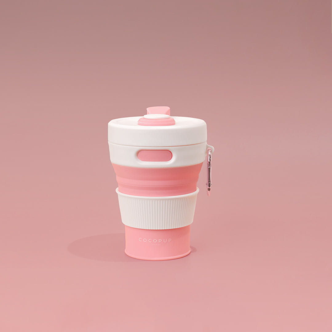 Plain Pink with White Lid Collapsible Silicone Travel Coffee Cup with Cocopup branding and carabiner clip.