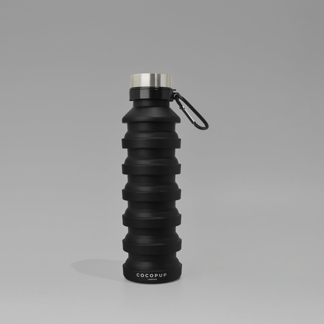 Plain Black Silicone Collapsible Water Bottle with Cocopup Branding and Carabiner Clip.