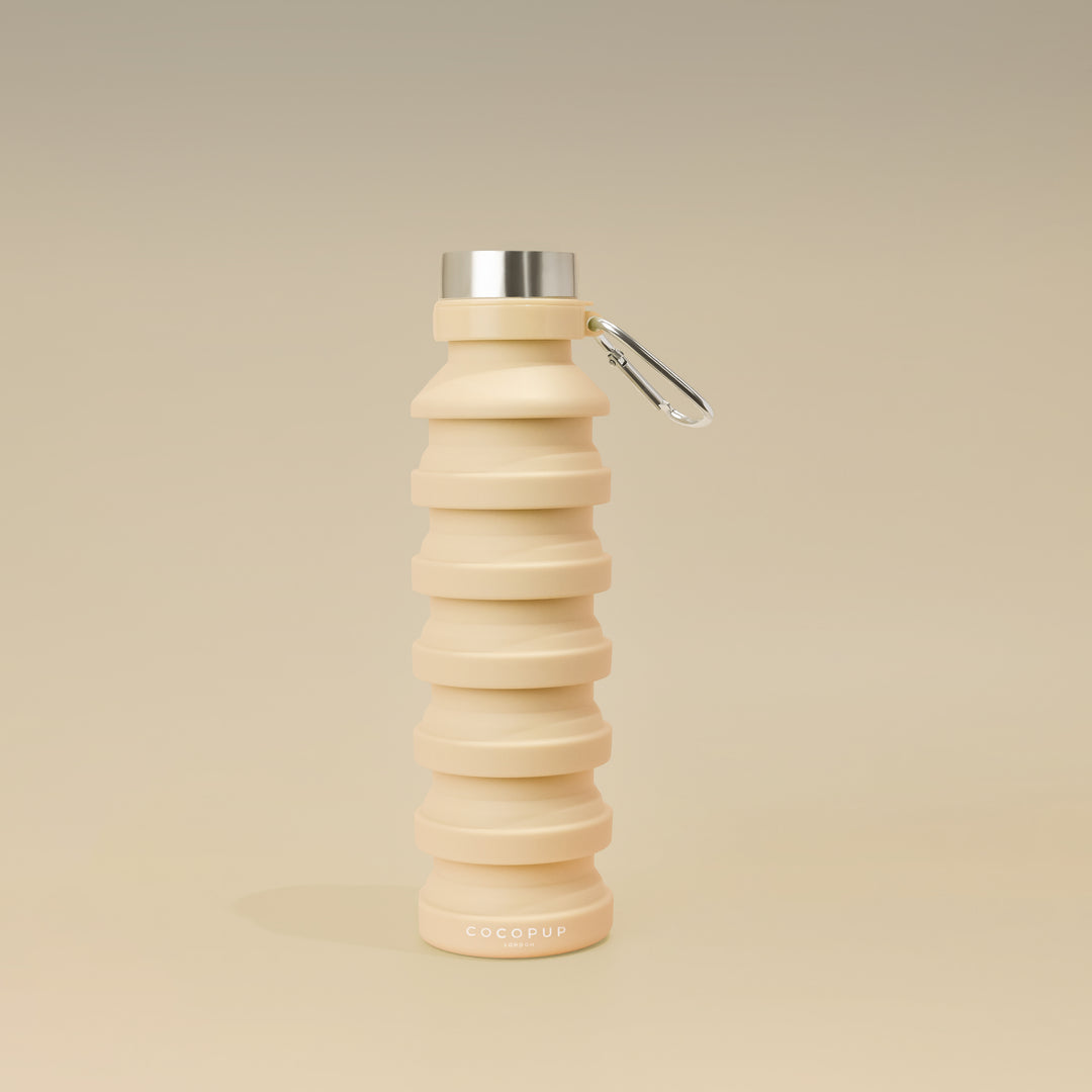 Plain Nude Silicone Collapsible Water Bottle with Cocopup Branding, Stainless Steel Lid and Carabiner Clip.